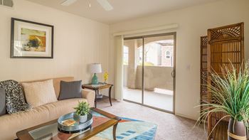 Desert Sands living room with glass sliding doors. 